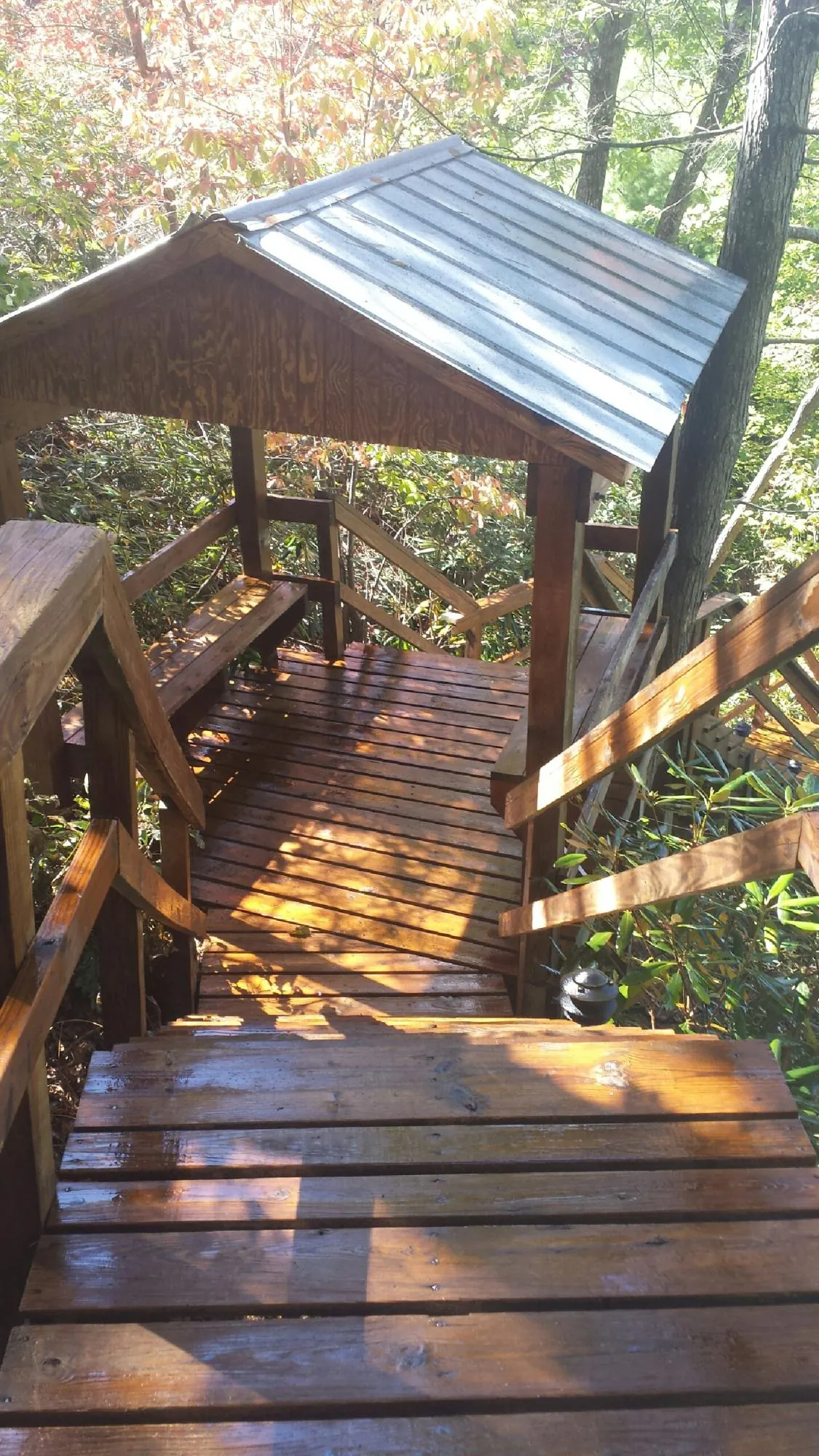 Freshly stained wood walkway and covered shelter with a metal roof in Somers